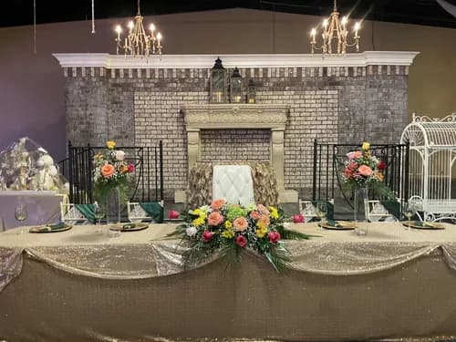 Quinceañera sweetheart table with fireplace backdrop at La Hacienda Event Venue